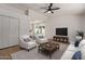Open-concept living room with modern decor, a ceiling fan, and seamless access to the kitchen at 934 E Wahalla Ln, Phoenix, AZ 85024