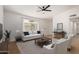 Bright living room featuring a neutral color palette, contemporary furnishings, and a ceiling fan at 934 E Wahalla Ln, Phoenix, AZ 85024