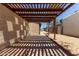 Covered patio area with a lattice roof providing shade over a brick-lined space at 934 E Wahalla Ln, Phoenix, AZ 85024