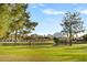 Stunning backyard with lush green grass and pond, with mountain views in the background at 94 Biltmore Estates Dr, Phoenix, AZ 85016
