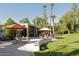 Expansive backyard patio with lush lawn, mature trees, and outdoor seating areas at 94 Biltmore Estates Dr, Phoenix, AZ 85016