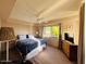 Comfortable bedroom with large window, carpet floors, and ceiling fan at 94 Biltmore Estates Dr, Phoenix, AZ 85016