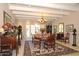 Formal dining room with chandelier, french doors, and vintage furniture at 94 Biltmore Estates Dr, Phoenix, AZ 85016