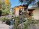 Unique home featuring an asymmetrical roofline, an adjacent pond, and lush landscaping at 94 Biltmore Estates Dr, Phoenix, AZ 85016