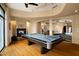 Spacious game room with a billiard table and a fireplace, perfect for entertaining guests at 94 Biltmore Estates Dr, Phoenix, AZ 85016
