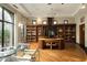Well-lit home office featuring custom built-in bookshelves and a unique curved wooden desk at 94 Biltmore Estates Dr, Phoenix, AZ 85016