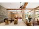 Bright living room boasting high ceilings, exposed wood beams, stone fireplace, and ample seating at 94 Biltmore Estates Dr, Phoenix, AZ 85016