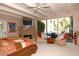 Bright main bedroom with fireplace, ceiling fan, and a large window with seating at 94 Biltmore Estates Dr, Phoenix, AZ 85016