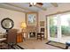 Cozy office with corner fireplace, stone tile flooring, and views to the yard at 94 Biltmore Estates Dr, Phoenix, AZ 85016