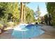 Inviting backyard pool with lush landscaping, mature trees, and patio area at 94 Biltmore Estates Dr, Phoenix, AZ 85016