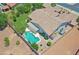 Drone view of a home featuring a sparkling pool, covered patio, and low-maintenance landscaping at 23090 S 201St St, Queen Creek, AZ 85142