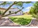 Lush backyard with mature landscaping, a well maintained lawn, and a paver stone border at 23090 S 201St St, Queen Creek, AZ 85142
