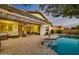 Back patio with furniture, a swimming pool and desert landscaping offers space for outdoor gatherings at 23090 S 201St St, Queen Creek, AZ 85142