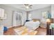 Bright bedroom with wood floors, ceiling fan, and a colorful rug at 23090 S 201St St, Queen Creek, AZ 85142