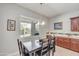 Charming dining area with backyard views, complete with wooden table and complementary cabinetry at 23090 S 201St St, Queen Creek, AZ 85142