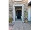 Inviting front entrance with stone accents, potted plants, and decorative lighting at 23090 S 201St St, Queen Creek, AZ 85142