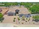 Charming single-story home featuring a three-car garage, desert landscaping, and stone accents at 23090 S 201St St, Queen Creek, AZ 85142