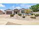 Inviting single-story home with a three-car garage, desert landscaping, and stone walkway at 23090 S 201St St, Queen Creek, AZ 85142