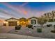 Charming single-story home with desert landscaping and a welcoming entrance at twilight at 23090 S 201St St, Queen Creek, AZ 85142