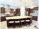 A gourmet kitchen features a large island, stainless steel appliances, and stylish pendant lighting at 23090 S 201St St, Queen Creek, AZ 85142