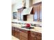 This home features a well-equipped kitchen with granite counters, stainless hood, and tiled backsplash at 23090 S 201St St, Queen Creek, AZ 85142