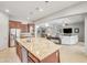 Bright and open kitchen with a large island and stainless steel appliances seamlessly flowing into the living space at 23090 S 201St St, Queen Creek, AZ 85142