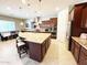 A spacious kitchen boasts a center island with seating, granite countertops, and modern appliances at 23090 S 201St St, Queen Creek, AZ 85142