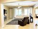 A comfortable living room offers ample seating, neutral tones, and lots of natural light at 23090 S 201St St, Queen Creek, AZ 85142