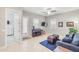 Cozy living room with tiled floor, a navy sofa, and a piano at 23090 S 201St St, Queen Creek, AZ 85142