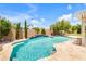 Backyard pool has waterfall features, lush landscaping, and a large patio area perfect for outdoor enjoyment at 23090 S 201St St, Queen Creek, AZ 85142