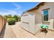 Backyard shed on a paver path provides extra storage space next to desert landscaping at 23090 S 201St St, Queen Creek, AZ 85142