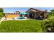 Beautiful backyard with green grass, pool, patio, and privacy fence, perfect for entertaining at 10342 E Obispo Ave, Mesa, AZ 85212