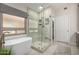 Bright bathroom boasts a modern shower, soaking tub, and a large window at 10342 E Obispo Ave, Mesa, AZ 85212