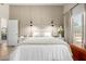 Bright bedroom with a luxurious bed, soft lighting, and a view of the outdoor area at 10342 E Obispo Ave, Mesa, AZ 85212