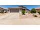 Inviting single-Gathering home with a two-car garage, complemented by desert landscaping and lush greenery at 10342 E Obispo Ave, Mesa, AZ 85212