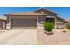 Charming single-story home with a well-manicured front yard and attached two-car garage at 10342 E Obispo Ave, Mesa, AZ 85212