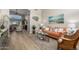 Inviting living space with ample seating, a cozy rug, light-filled windows, and wood-look flooring at 10342 E Obispo Ave, Mesa, AZ 85212