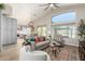 Open-concept living room with backyard views, high ceilings, ceiling fan, neutral colors, and wood floors at 10342 E Obispo Ave, Mesa, AZ 85212