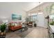 Bright living room with vaulted ceilings, large windows, stylish furniture, and wood-look floors at 10342 E Obispo Ave, Mesa, AZ 85212