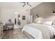 A serene bedroom featuring neutral tones, wood-look flooring, panel molding and an ensuite bathroom at 10342 E Obispo Ave, Mesa, AZ 85212