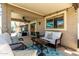 Comfortable covered patio with woven chairs and a glass table for outdoor relaxation at 10342 E Obispo Ave, Mesa, AZ 85212