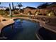 Backyard with a pool, hot tub, manicured grass, string lights and landscaping at 10342 E Obispo Ave, Mesa, AZ 85212