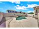 Backyard oasis with a lagoon style pool, rock features, a garden, and privacy fence at 1147 E Harvest Rd, San Tan Valley, AZ 85140