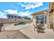Relaxing backyard retreat with a private pool, concrete patio, and comfortable seating area at 1147 E Harvest Rd, San Tan Valley, AZ 85140