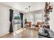 Entertaining area with a bar, shelving, leather chairs, and a sliding glass door to the patio at 1147 E Harvest Rd, San Tan Valley, AZ 85140