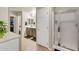 Bathroom featuring a glass door shower, cabinet vanity, and walk-in closet for storage and convenience at 1147 E Harvest Rd, San Tan Valley, AZ 85140