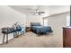 Bedroom with carpet floor, a bed, ceiling fan, a vanity table and makeup, and natural lighting at 1147 E Harvest Rd, San Tan Valley, AZ 85140
