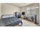 Bedroom featuring carpet, a metal frame bed, dark furniture, a window, and a cooling fan at 1147 E Harvest Rd, San Tan Valley, AZ 85140