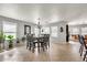 Dining area featuring a chandelier, view of den and hard surface flooring at 1147 E Harvest Rd, San Tan Valley, AZ 85140
