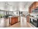 Open concept kitchen with tile flooring, stainless steel appliances, and dining area at 1147 E Harvest Rd, San Tan Valley, AZ 85140